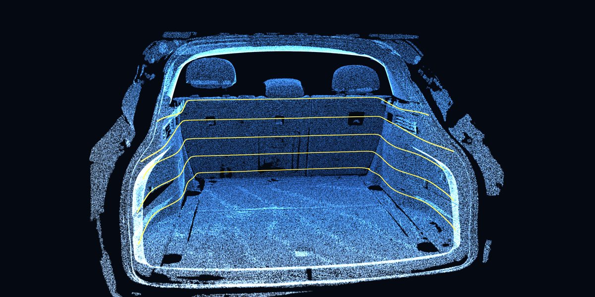 Looking into the vehicle load space through the tailgate opening, rendered from the scan, with amber contour lines showing the shape of the usable space.
